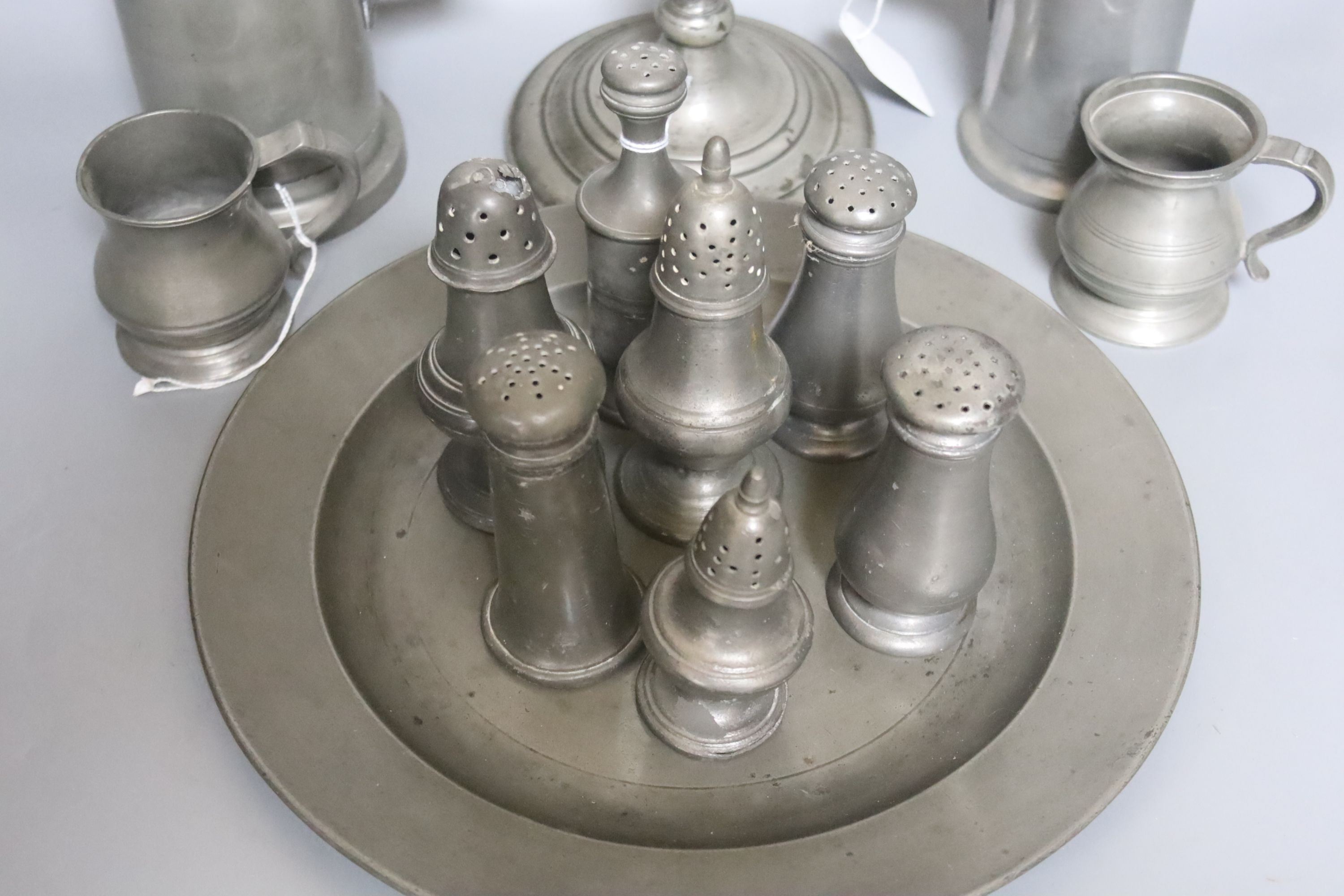 Seven pewter salt or pepper pots, a goblet, 23.5cm, four measures and a plate